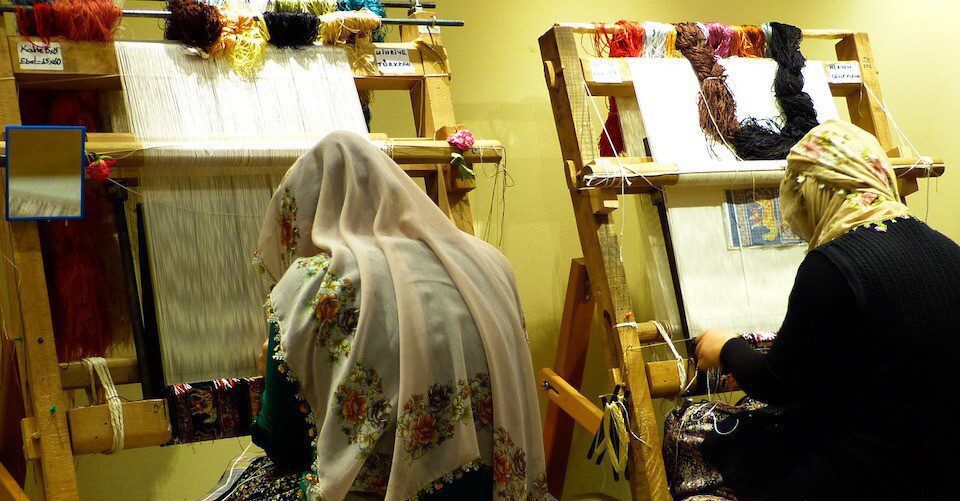 Two Moroccan women are weaving Two Moroccan women are weaving